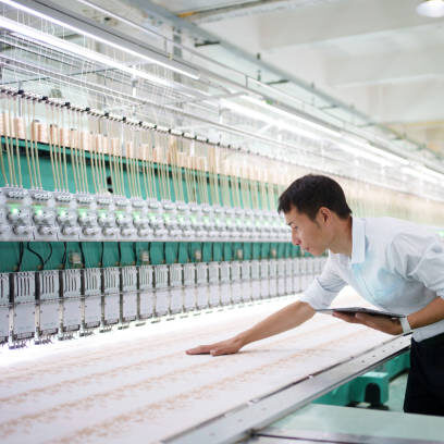 skilled worker inspecting loom